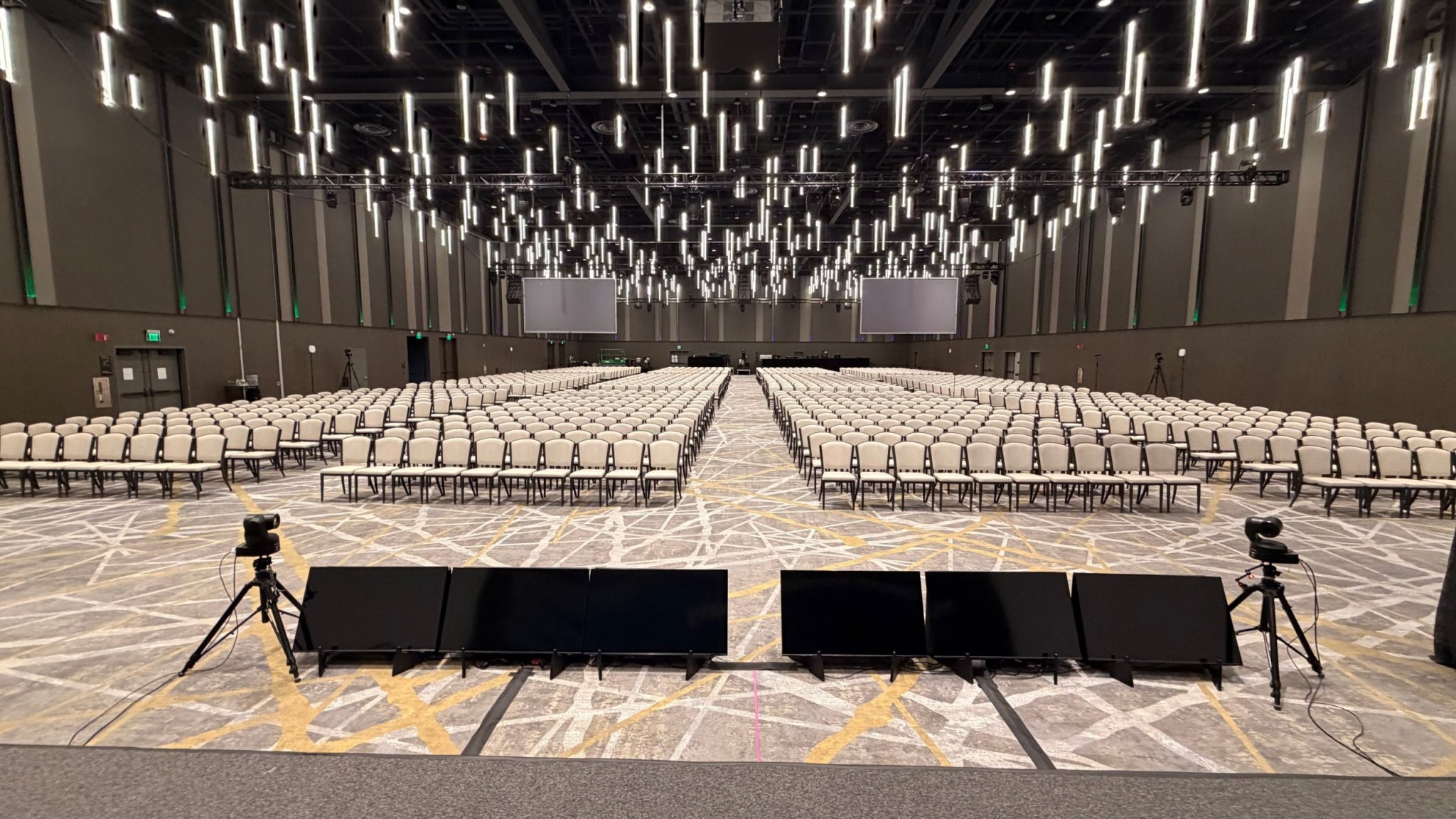 View from the stage over a large ballroom with confidence monitors and PTZ cameras set