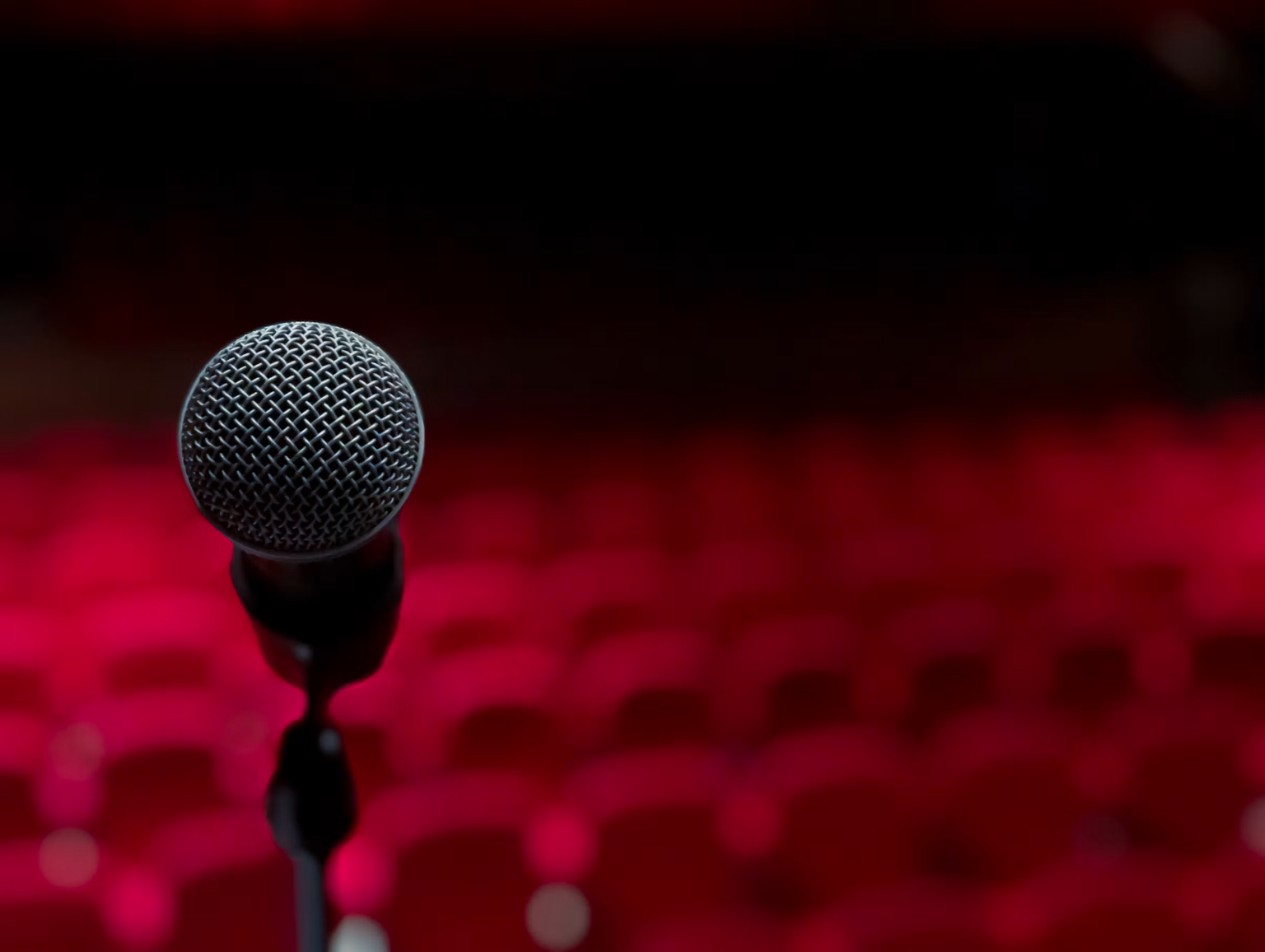 Microphone on a stand downstage in front of an empty theater before the doors open